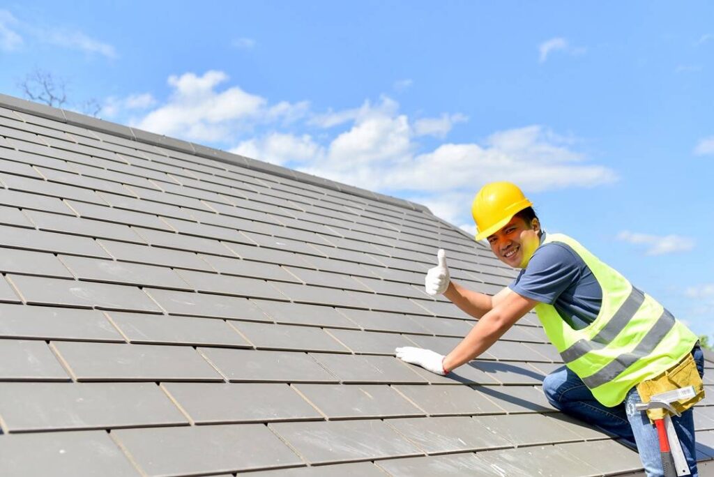 Professional roofer on top of a home's roof