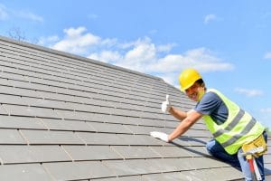 Man on top of roof giving a thumbs up | Ace Roofing Company