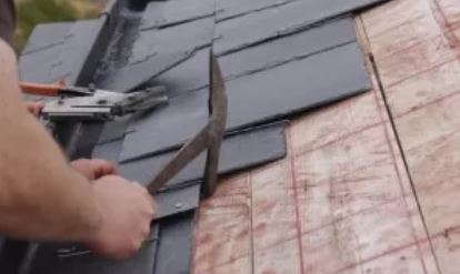 Person using roof replacement tools