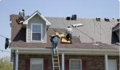 Roofers replacing a roof on a home
