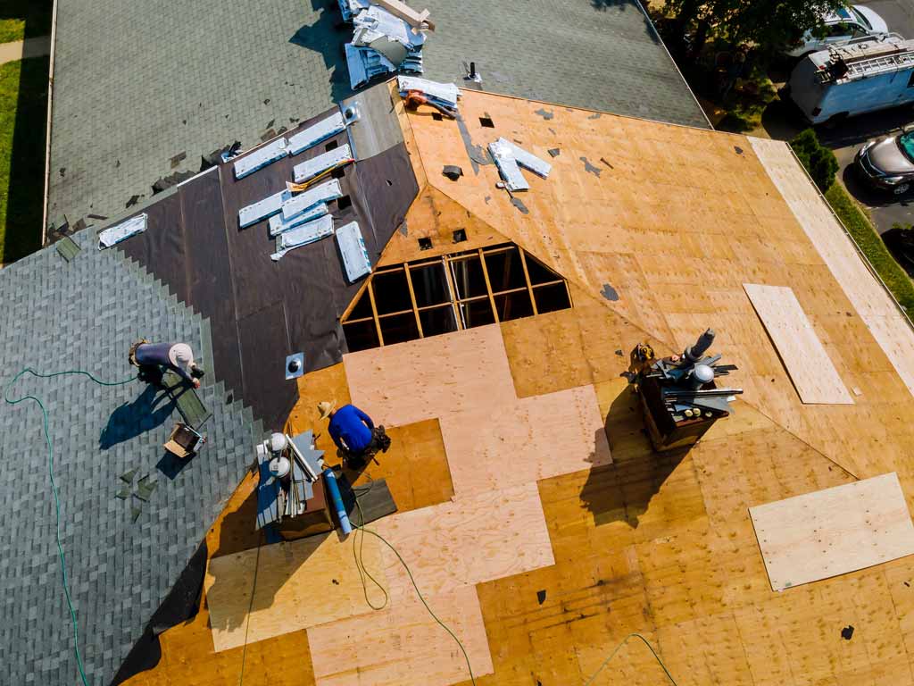 An apartment roof being replaced