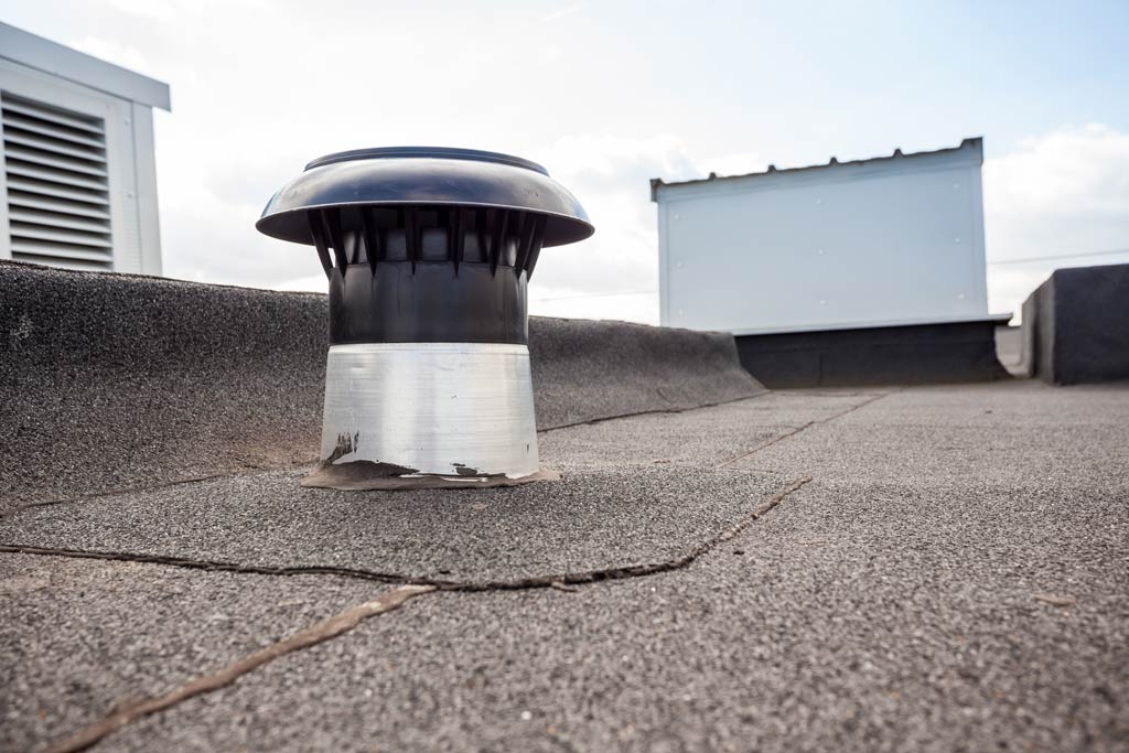 A roof vent on a flat commercial roof 