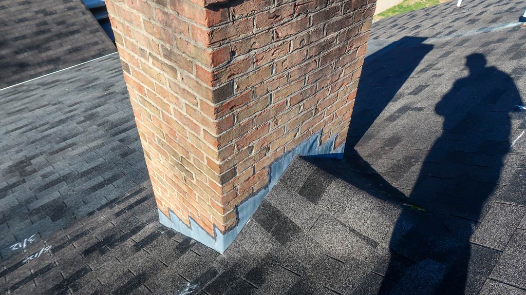 Step flashing by a chimney